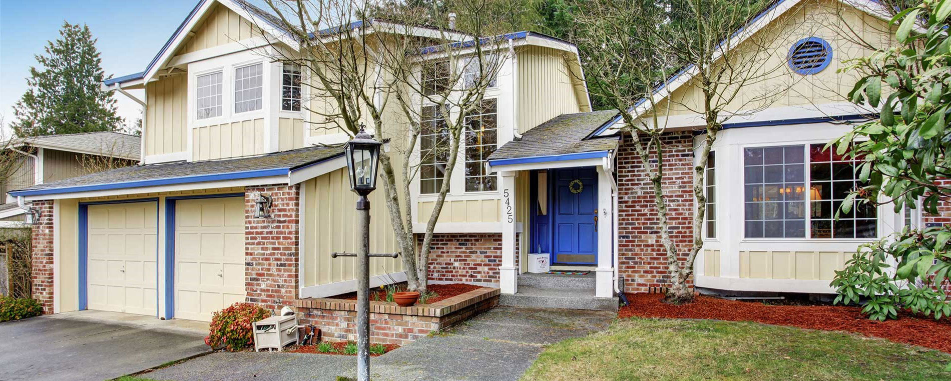 A view to a suburban house with double garage